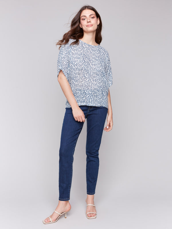 Dolman sleeves on a blue and white fish-patterned blouse by Charlie B.