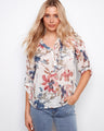 Floral blouse with a stylish Henley neckline, perfect for casual outings. The delicate design adds charm to any outfit by Charlie B.