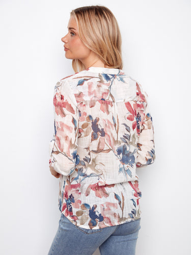 Enjoy the adjustable roll-up sleeves on this beautiful floral blouse, providing comfort and adaptability throughout the day by Charlie B.