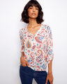Floral blouse with a Henley neckline, showcasing vibrant patterns and adjustable roll-up sleeves for versatile styling by Charlie B.