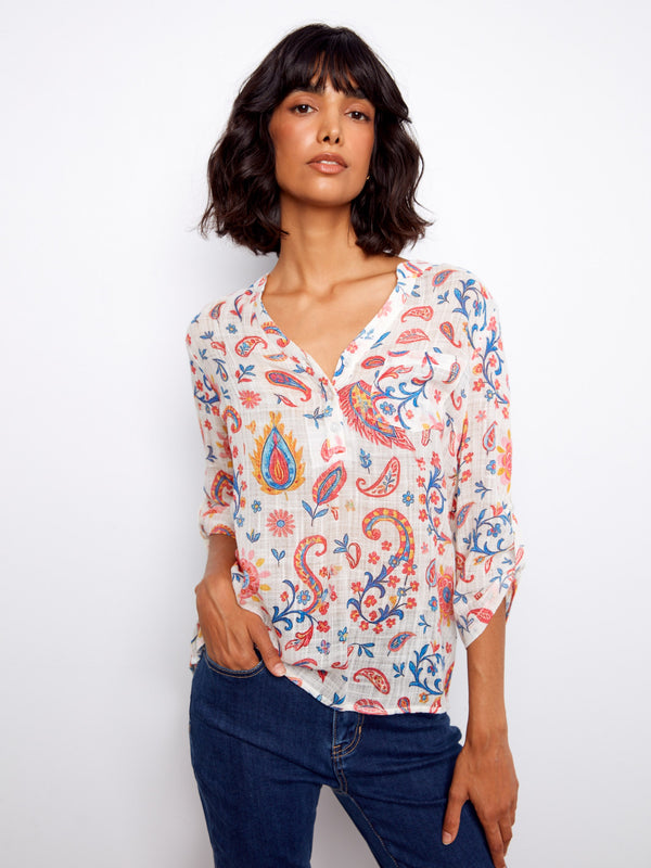 Floral blouse with a Henley neckline, showcasing vibrant patterns and adjustable roll-up sleeves for versatile styling by Charlie B.