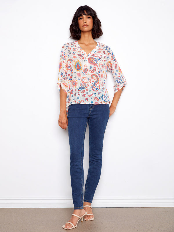 Elegant top with adjustable roll-up sleeves, offering both comfort and style in a lively print by Charlie B.