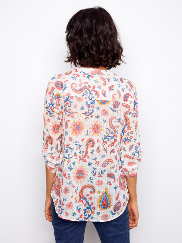 Back view of the floral blouse highlighting its seamless design and vibrant color palette by Charlie B.