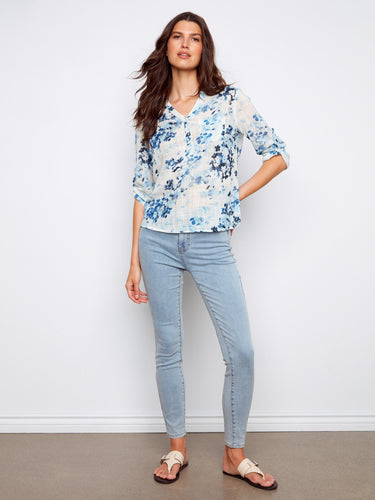 Embrace effortless style with this floral blouse featuring a practical chest pocket. A versatile addition from Charlie B.