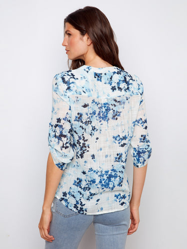 Experience elegance in this lightweight floral blouse, perfect for layering or wearing alone. A sophisticated choice by Charlie B.