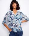 Women's blouse with floral pattern and chest pocket, featuring a Henley neckline and roll-up sleeves by Charlie B.