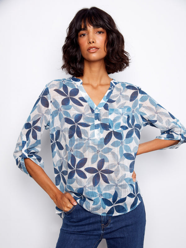 Women's blouse with floral pattern and chest pocket, featuring a Henley neckline and roll-up sleeves by Charlie B.
