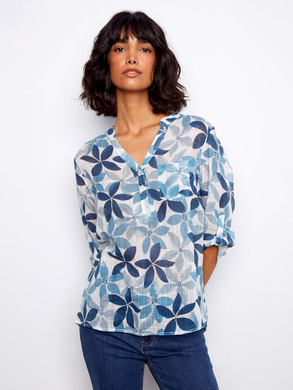 Blouse with floral motif, featuring a Henley neckline and adjustable roll-up sleeves for versatile styling by Charlie B.