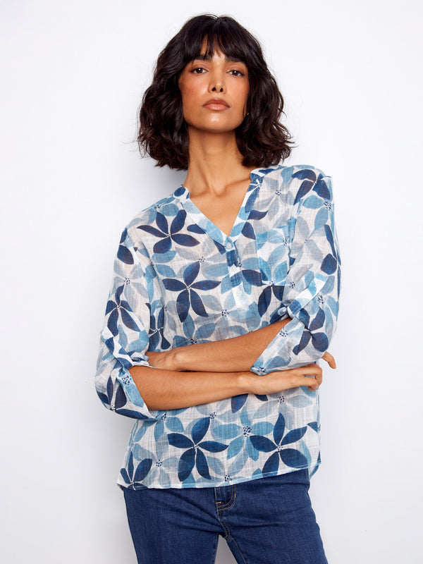 Women's floral blouse with adjustable roll-up sleeves, highlighted by a stylish chest pocket and Henley neckline by Charlie B.