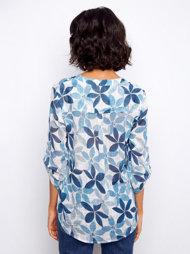 Floral print blouse designed for versatility with its adjustable roll-up sleeves and classic Henley neckline by Charlie B.