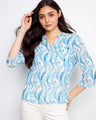 Blue patterned blouse with a stylish Henley neckline, perfect for casual outings. Designed by Charlie B.