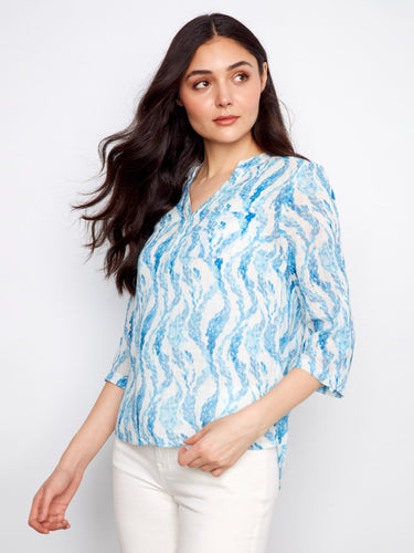 Elegant top with a convenient chest pocket, adding practicality to its fashionable look. Crafted by Charlie B.