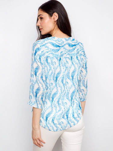 Comfortable blouse with adjustable roll-up sleeves, offering flexibility and style in one piece. By Charlie B.