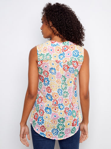 Colorful floral top showcasing a sleeveless design, perfect for warm weather fashion. Designed by Charlie B.