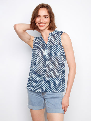 This sleeveless blouse showcases a geometric pattern and a convenient chest pocket by Charlie B.