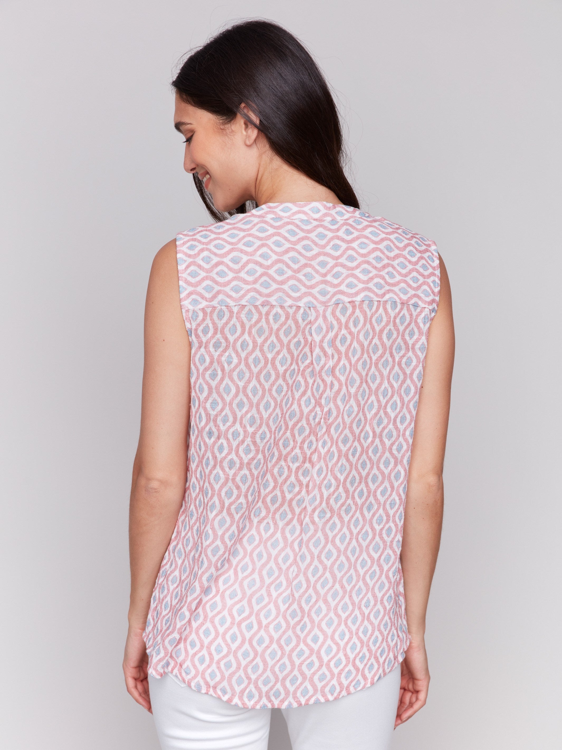 Geometric pattern enhances the elegance of this sleeveless high-low hem top by Charlie B.
