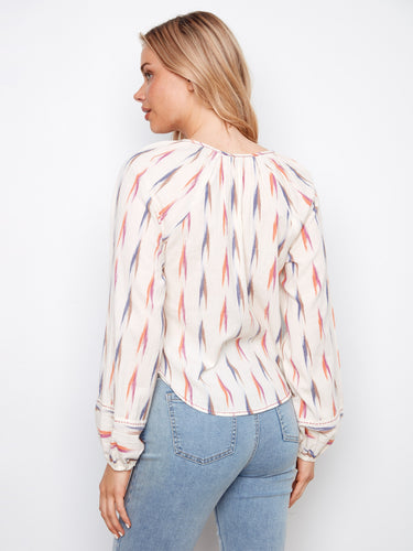 Long raglan sleeves give this ikat print blouse a relaxed and flowing silhouette, perfect for any casual outing by Charlie B.
