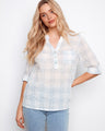 Plaid blouse featuring a chest pocket and adjustable roll-up sleeves, perfect for versatile styling by Charlie B.