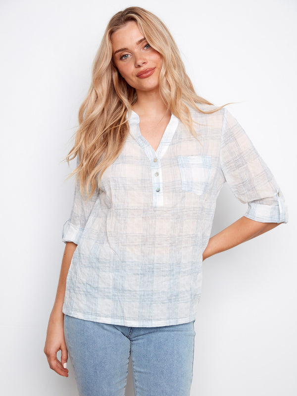 Plaid blouse featuring a chest pocket and adjustable roll-up sleeves, perfect for versatile styling by Charlie B.