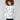 White sweater with a black cheetah print, showcasing a chic drop shoulder design for added style by Charlie B.