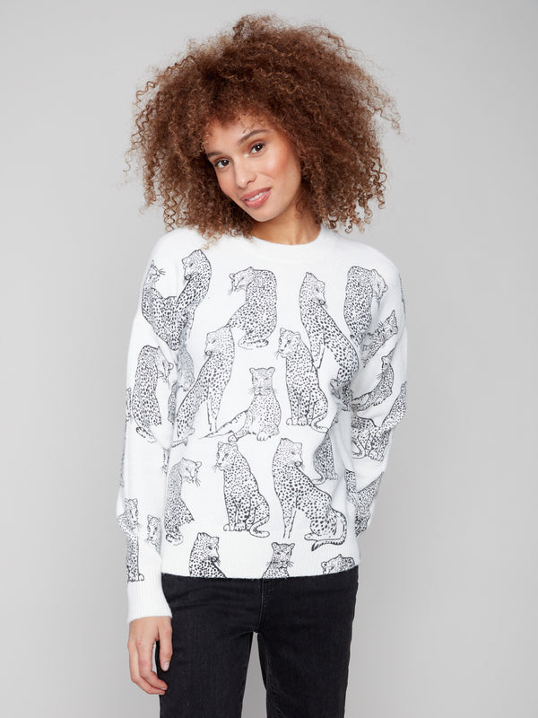White sweater with a black cheetah print, showcasing a chic drop shoulder design for added style by Charlie B.