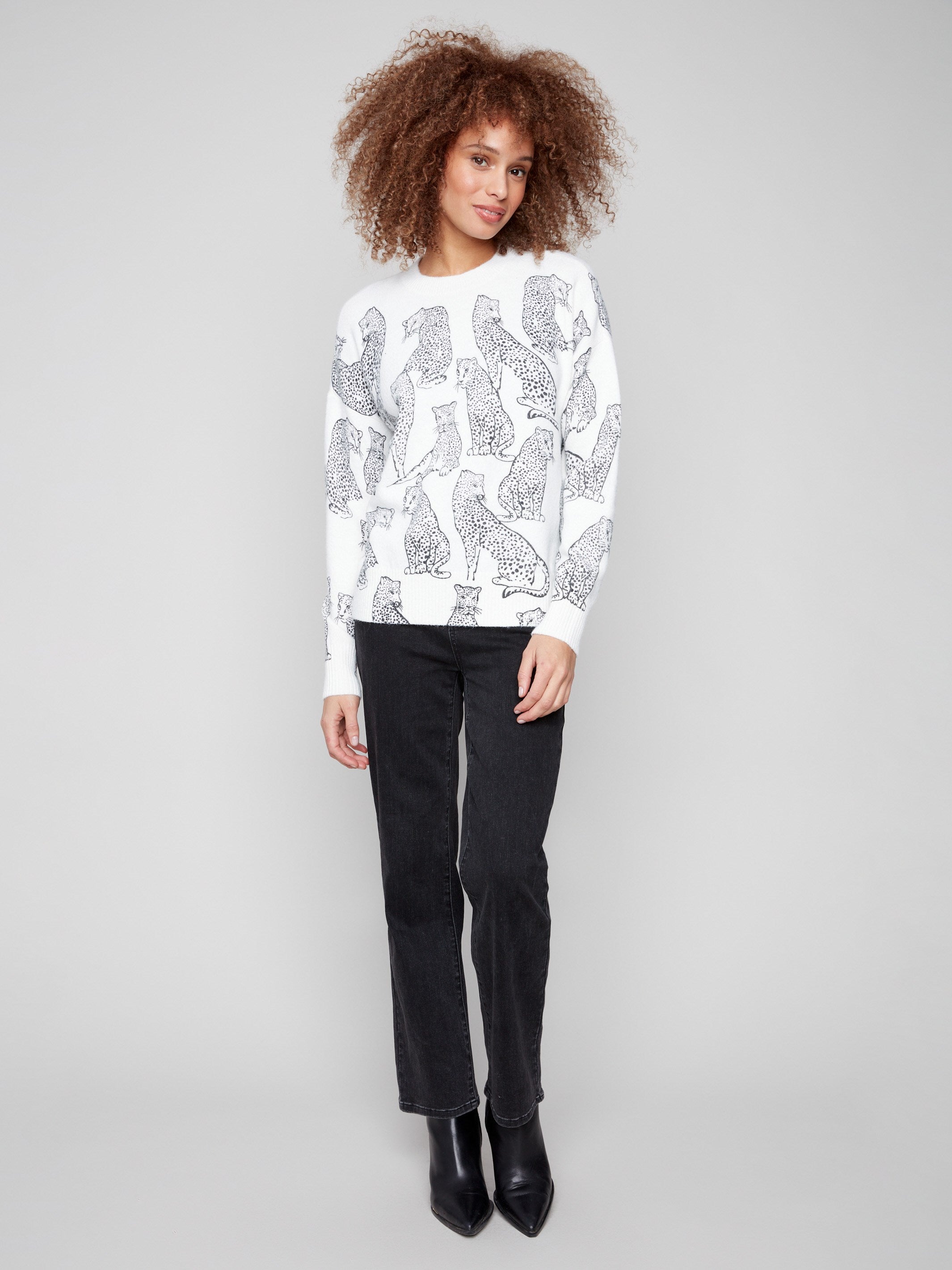 Elegant white sweater featuring black cheetah print and ribbed hemline and cuffs for a snug fit by Charlie B.