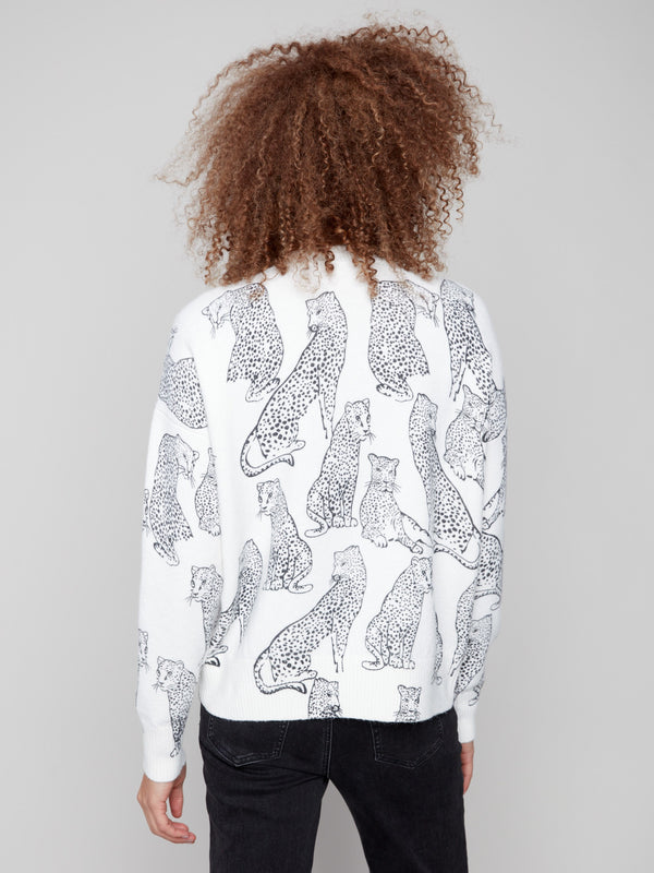 Trendy white sweater displaying a black cheetah pattern, complete with ribbed cuffs and hemline for elegance by Charlie B.