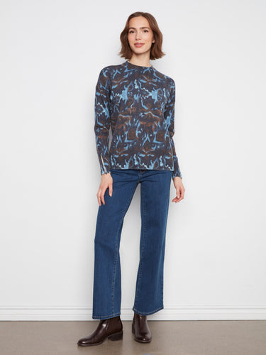 This cozy sweater's intricate design brings an artistic flair to any outfit you choose to wear by Charlie B.