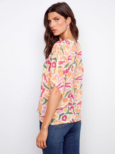 Abstract patterned blouse with lightweight cotton blend fabric and relaxed fit, showcasing short dolman sleeves by Charlie B.