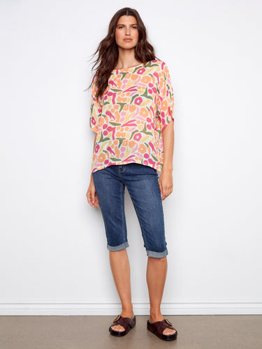 Stylish colorful print blouse in a relaxed fit with elbow-length dolman sleeves and crew neckline, perfect for any casual outing by Charlie B.