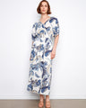 Maxi dress with a V-neck and intricate pattern, featuring a faux wrap design for elegance by Charlie B.