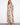 Floral dress featuring a V-neckline and vibrant colors, perfect for any occasion. Designed with elegance and style by Charlie B.