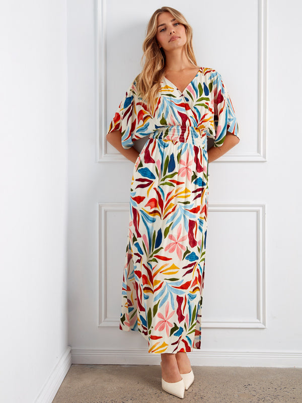 A colorful V-neck maxi dress featuring exquisite detailing and a playful pattern that stands out. Designed thoughtfully by Charlie B.