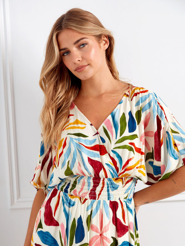 The faux wrap design adds sophistication to the vivid print of this elegant maxi dress, suitable for any event by Charlie B.