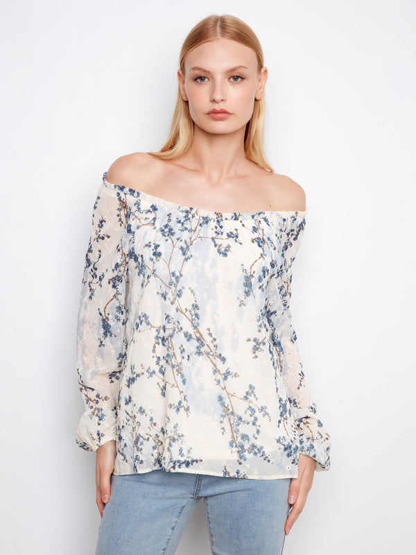 Chic blouse showcasing an off-the-shoulder neckline with delicate floral patterns, offering a stylish look for any occasion by Charlie B.