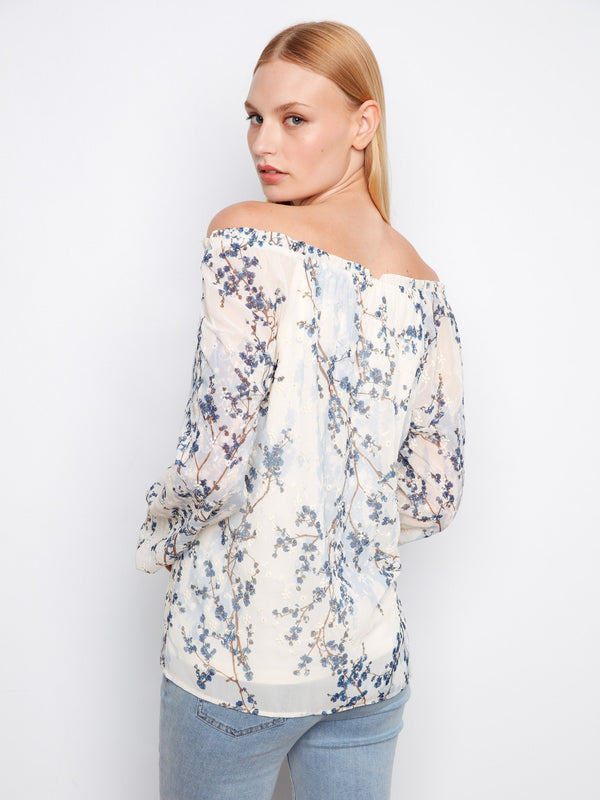 Fashionable off-the-shoulder blouse adorned with intricate floral prints, ideal for enhancing your wardrobe by Charlie B.