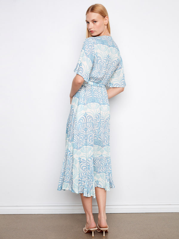 Chic faux wrap dress in light blue with a self-tie belt, showcasing an elegant Maeva pattern by Charlie B.