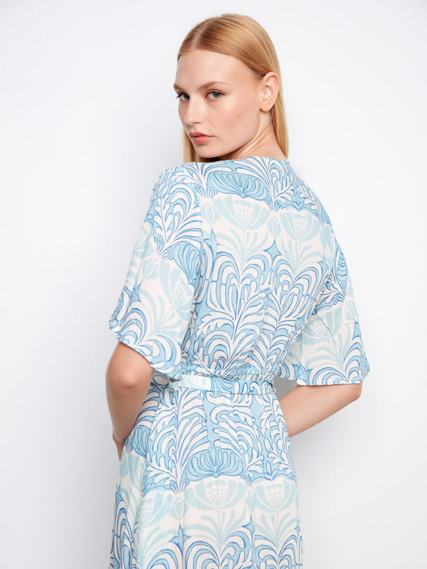 Elegant printed maxi dress featuring flutter sleeves and a sophisticated faux wrap silhouette by Charlie B.