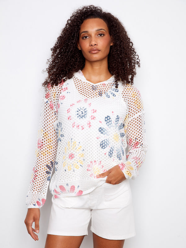 Vibrant fishnet crochet design with floral patterns, perfect for layering in style by Charlie B.