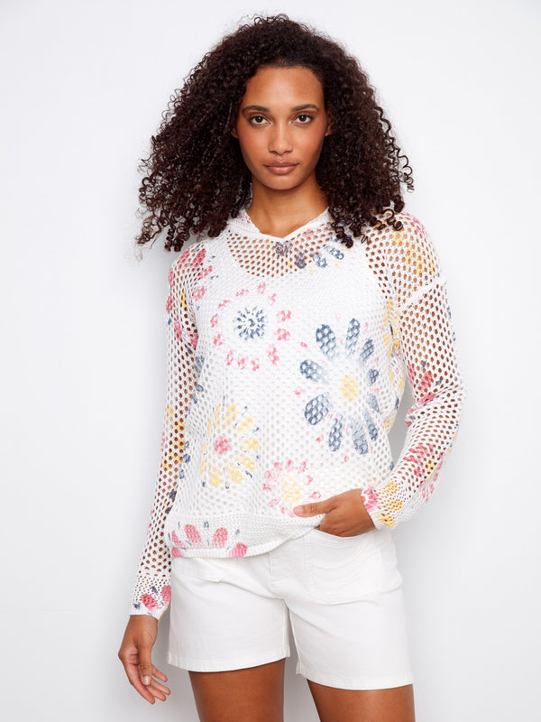 Bright floral patterns enhance the airy fishnet texture of this chic top by Charlie B.