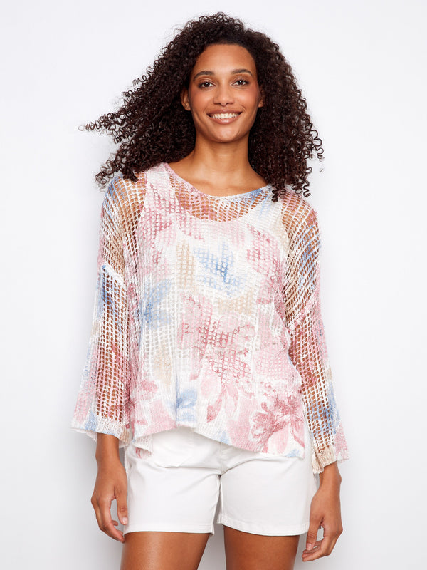 This floral mesh top features a loose fit, creating a relaxed and breezy look perfect for any casual outing by Charlie B.