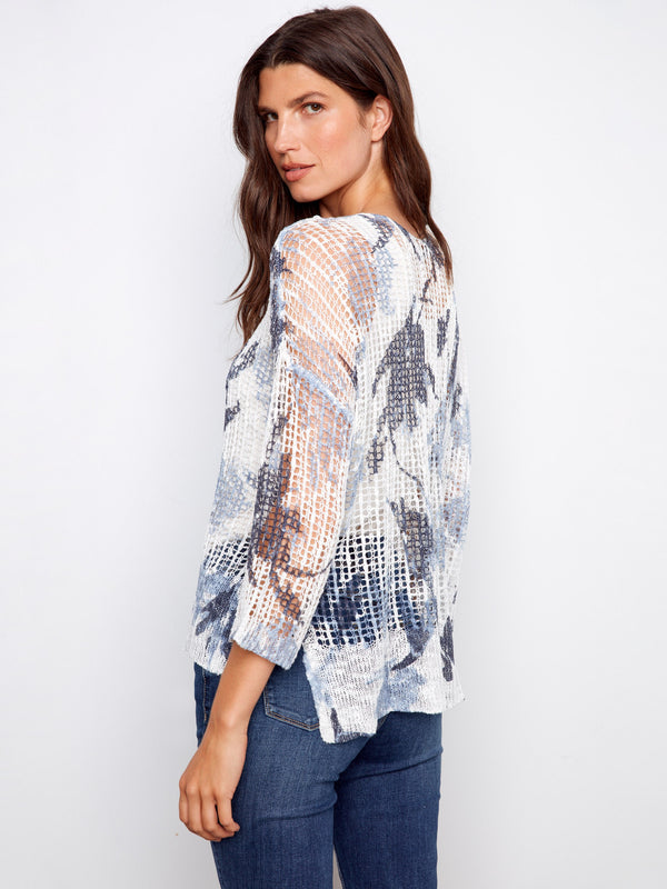 V-neck fishnet crochet sweater showcasing an abstract pattern and loose silhouette by Charlie B.