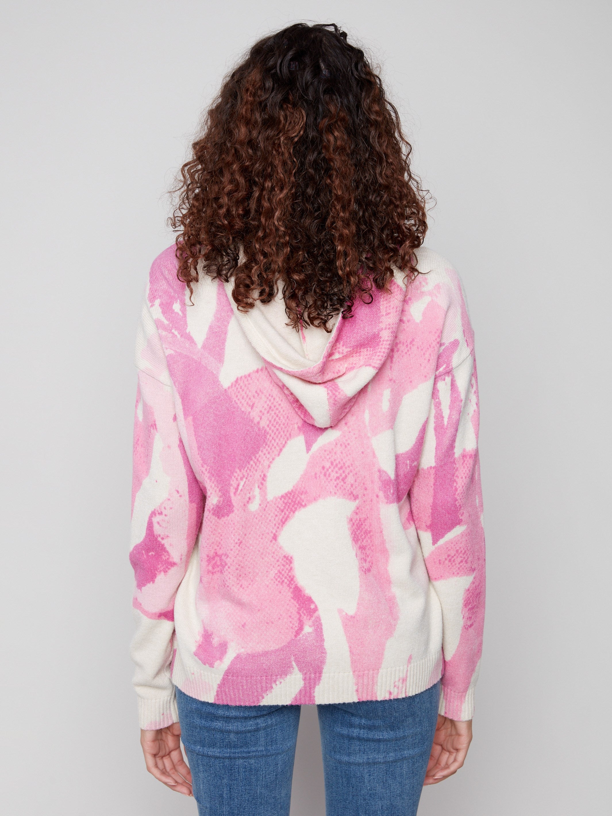 Elegant pink abstract printed hoodie showcasing the attached hood, adding flair to your wardrobe by Charlie B.