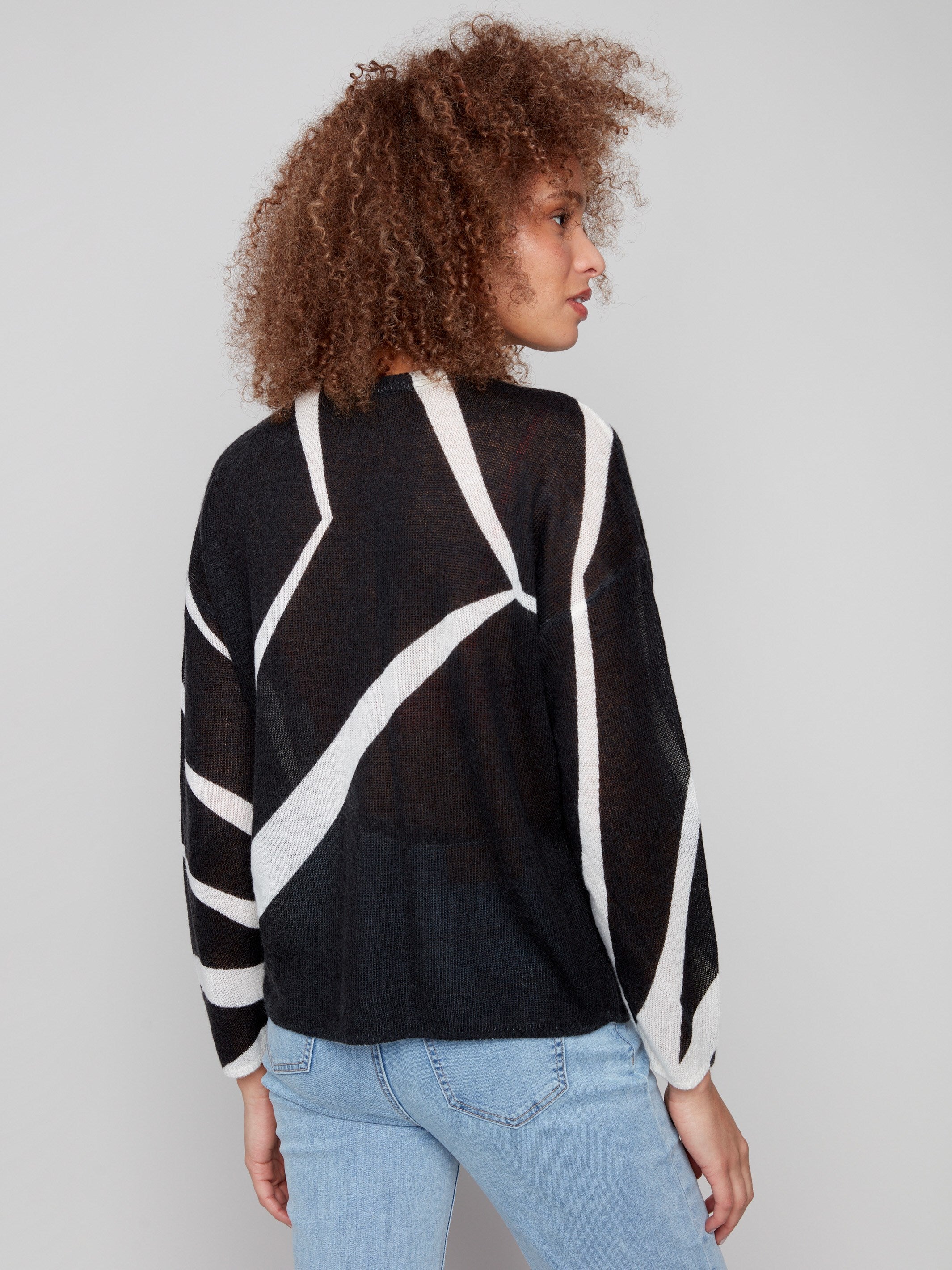 Long sleeves and semi-sheer fabric give this geometric patterned sweater an elegant touch by Charlie B.