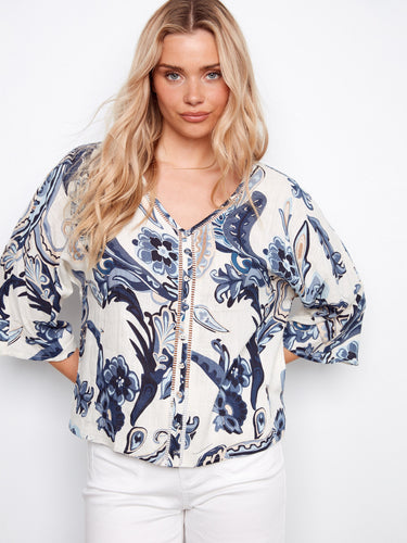 Vibrant Ibiza-inspired print on this blouse highlights the ladder stitch detail along the neckline by Charlie B.