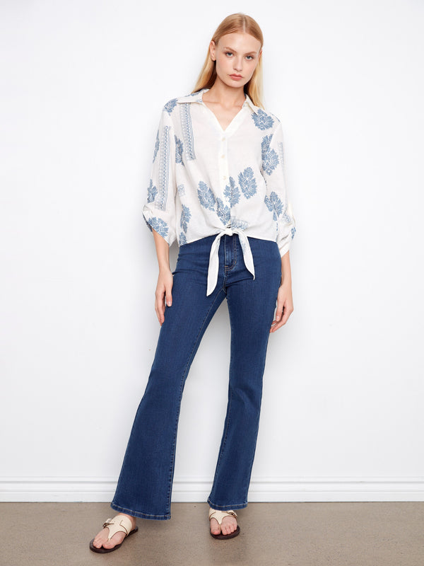 Stylish top featuring roll-up sleeves and a delicate print, perfect for casual outings. Crafted by Charlie B.