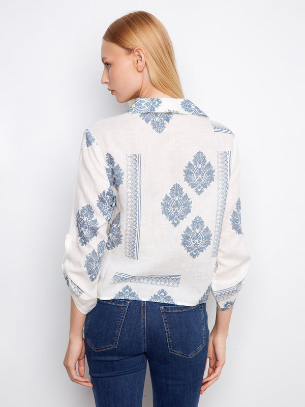 Chic blouse with a front-tie design, adding flair to any outfit. Blue floral motifs enhance its charm by Charlie B.