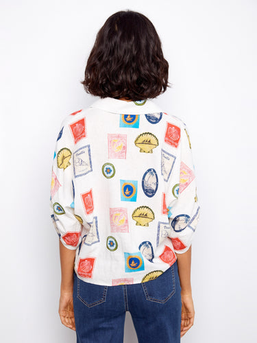 Stylish blouse adorned with postcards, offering short adjustable sleeves and an elegant V-neckline by Charlie B.