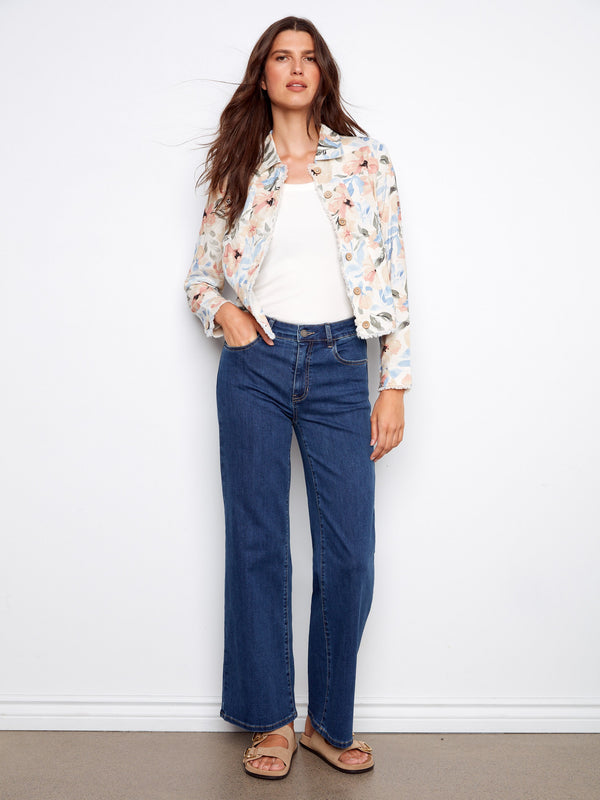 The frayed edges on this floral jacket create a unique look that pairs well with jeans or dresses alike for versatility. By Charlie B.