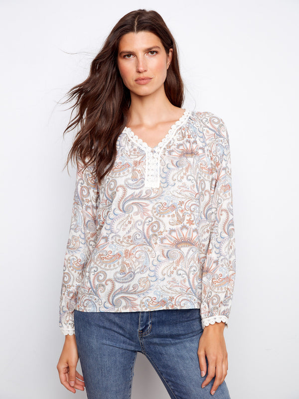 Raglan blouse featuring a paisley print and crochet trim, highlighted with a stylish notch neckline by Charlie B.